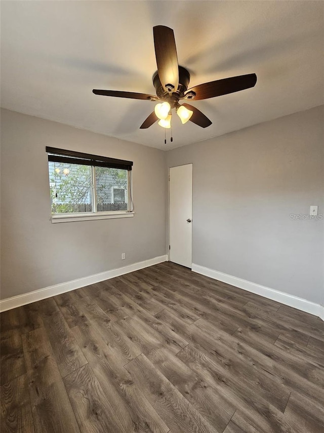 3763 Dartmouth Ave N, Saint Petersburg, FL 33713 - empty room with a ceiling fan, dark wood finished floors, and baseboards