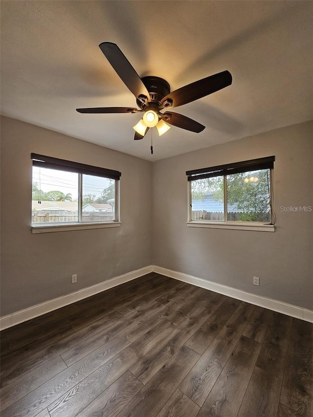 3763 Dartmouth Ave N, Saint Petersburg, FL 33713 - spare room with healthy amount of natural light, ceiling fan, dark wood-style floors, and baseboards