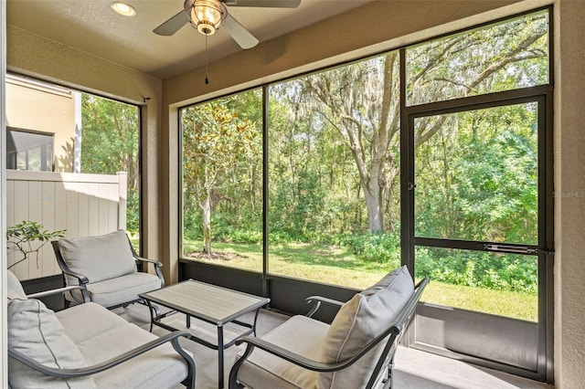 sunroom / solarium featuring ceiling fan and a healthy amount of sunlight