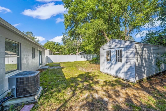 view of yard with a storage shed and cooling unit