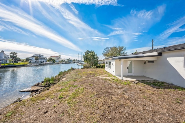 view of yard featuring a patio area and a water view