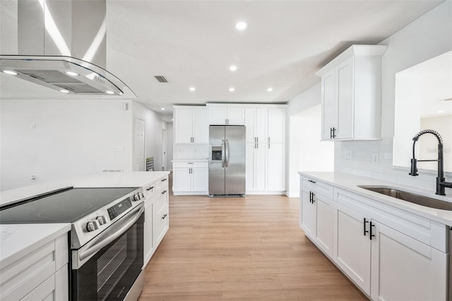 kitchen with stainless steel appliances, a sink, ventilation hood, light wood-type flooring, and tasteful backsplash