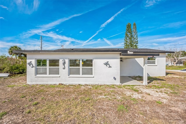 rear view of property with stucco siding