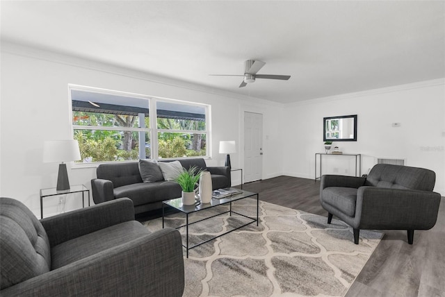 living room featuring ceiling fan, hardwood / wood-style floors, and ornamental molding