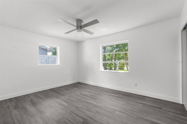 unfurnished room featuring ceiling fan and dark wood-type flooring