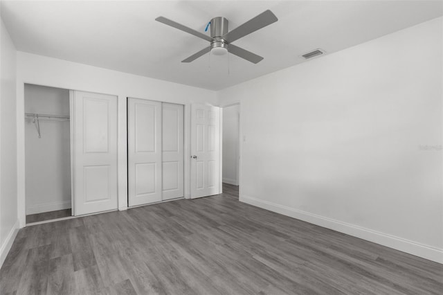 unfurnished bedroom with ceiling fan and wood-type flooring