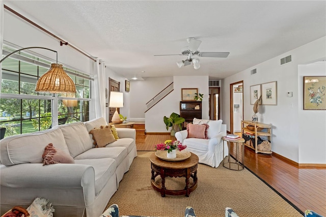 living room with ceiling fan and wood-type flooring