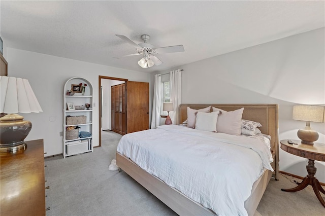 bedroom with ceiling fan and light colored carpet