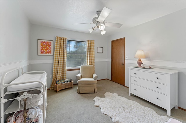 living area featuring ceiling fan and light carpet