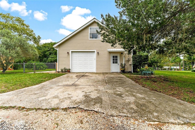 view of home's exterior with a garage and a yard