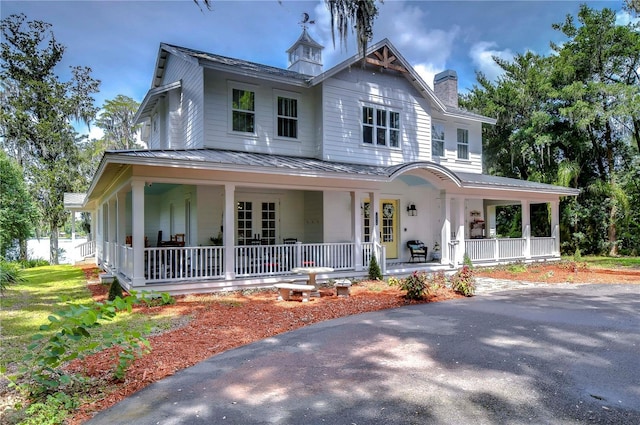 farmhouse featuring covered porch