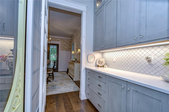 kitchen featuring backsplash, dark hardwood / wood-style floors, and crown molding