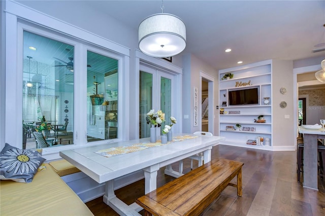 dining room featuring dark hardwood / wood-style flooring and built in features