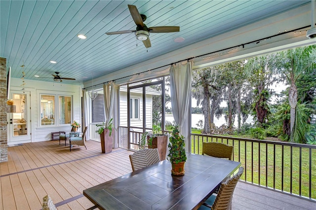 unfurnished sunroom with ceiling fan and wood ceiling