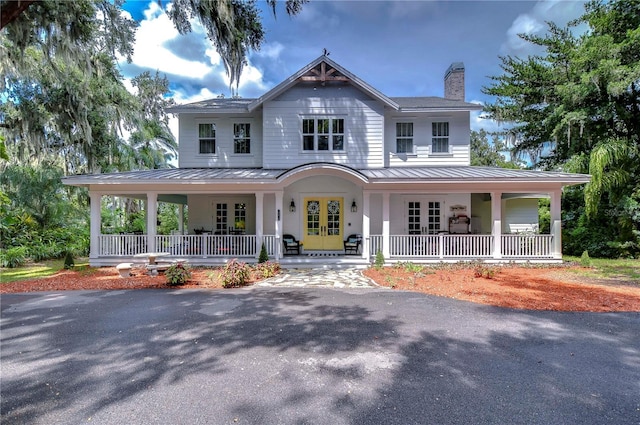 farmhouse inspired home featuring french doors and a porch