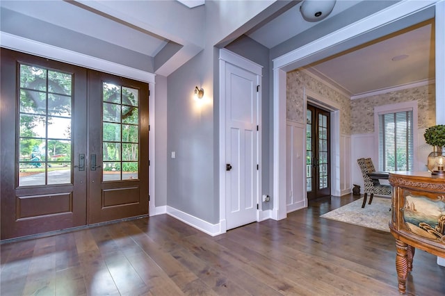 foyer entrance with crown molding, french doors, and dark hardwood / wood-style floors