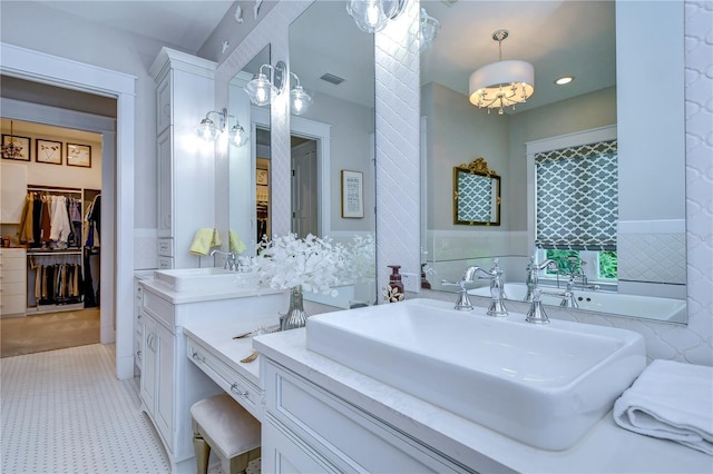 bathroom with vanity and tile walls