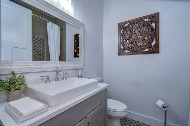 bathroom with tile patterned floors, vanity, toilet, and curtained shower