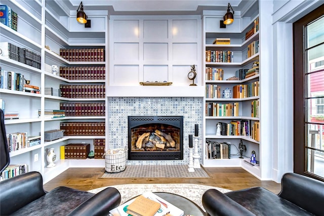 interior space featuring hardwood / wood-style floors, built in features, and a fireplace