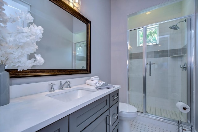 bathroom featuring toilet, vanity, and walk in shower