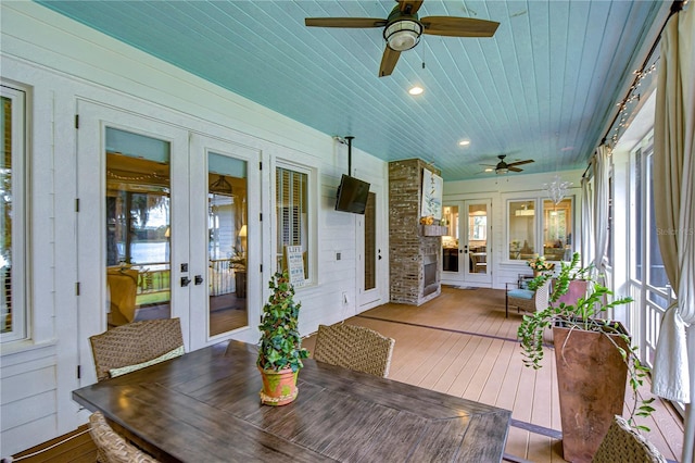 sunroom featuring french doors, ceiling fan, and a healthy amount of sunlight