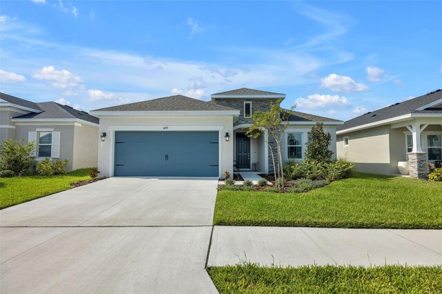 view of front of home with a garage and a front lawn