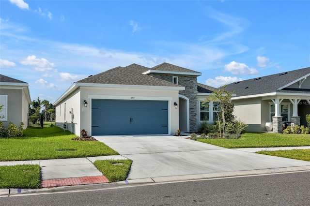 view of front of home with a garage, a shingled roof, concrete driveway, a front lawn, and stucco siding