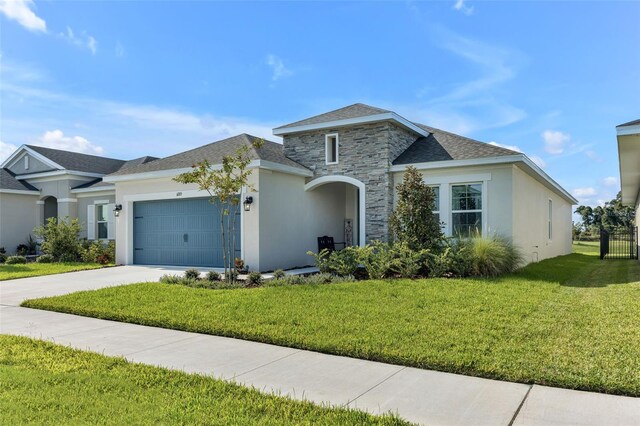 view of front of house with a garage and a front lawn