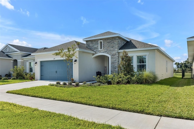 view of front of home with a garage, stone siding, concrete driveway, stucco siding, and a front yard