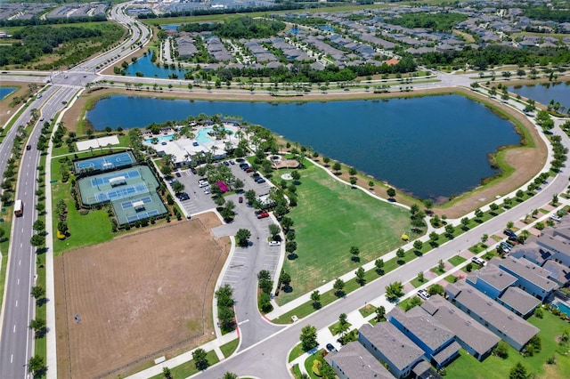 drone / aerial view with a water view and a residential view