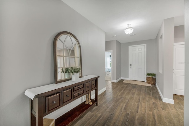 entryway with baseboards and dark wood finished floors