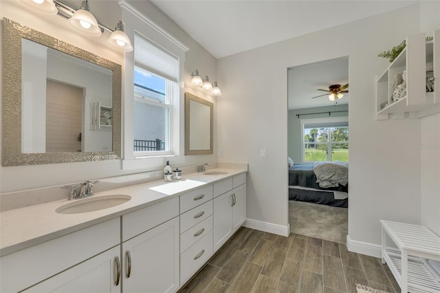 bathroom with wood-type flooring, vanity, and ceiling fan