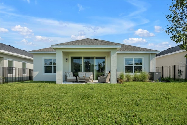 back of house with stucco siding, a fenced backyard, a lawn, and an outdoor hangout area