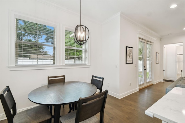 dining area featuring plenty of natural light, crown molding, and dark hardwood / wood-style flooring