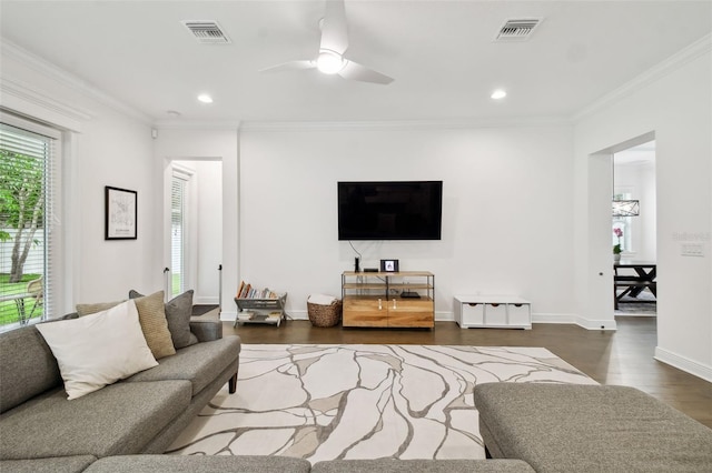 living room with ornamental molding, dark hardwood / wood-style floors, and ceiling fan