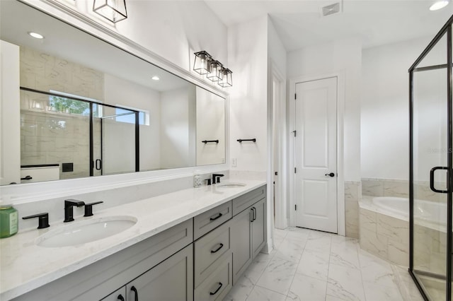 bathroom featuring vanity and shower with separate bathtub