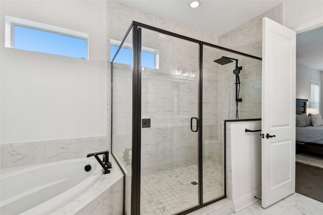 bathroom featuring shower with separate bathtub