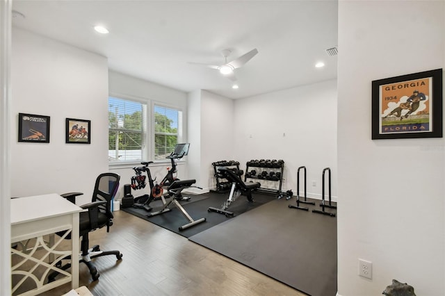 workout room with hardwood / wood-style flooring and ceiling fan