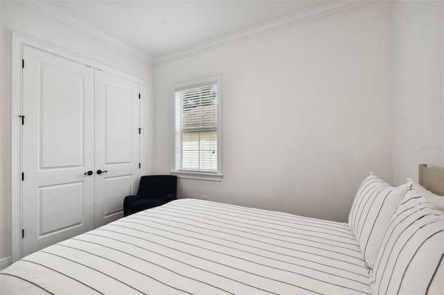 bedroom featuring ornamental molding and a closet