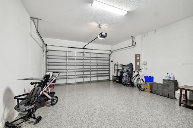 garage featuring electric panel and a garage door opener