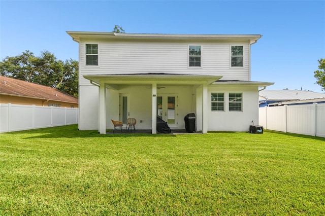 back of house featuring a yard and a patio