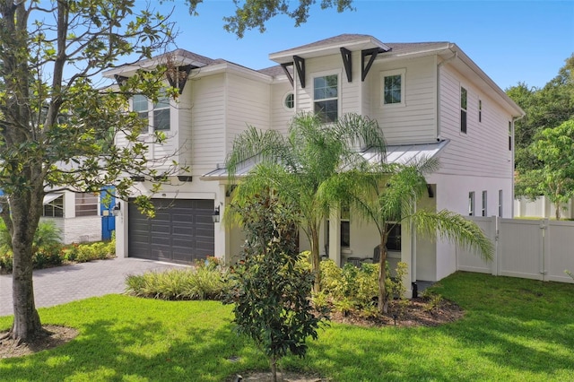 view of front of home with a front yard and a garage