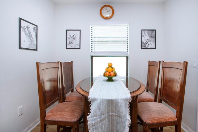 dining area with hardwood / wood-style flooring