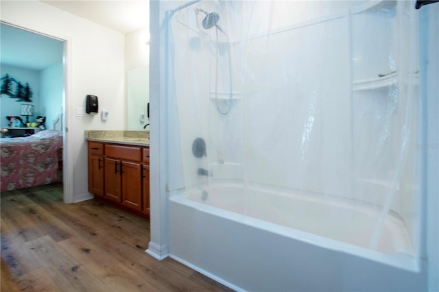 bathroom with hardwood / wood-style flooring, shower / washtub combination, and vanity