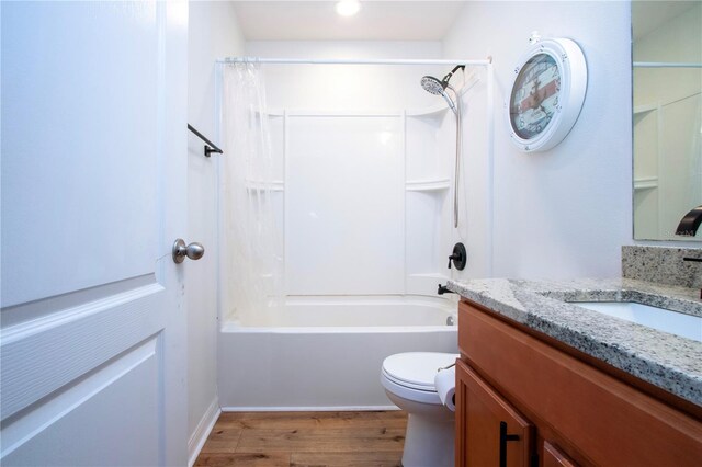 full bathroom with shower / bath combination with curtain, toilet, hardwood / wood-style flooring, and vanity