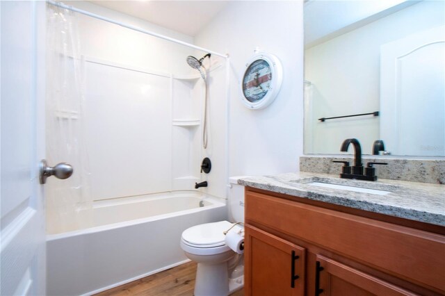 full bathroom featuring hardwood / wood-style flooring, toilet, shower / tub combination, and vanity