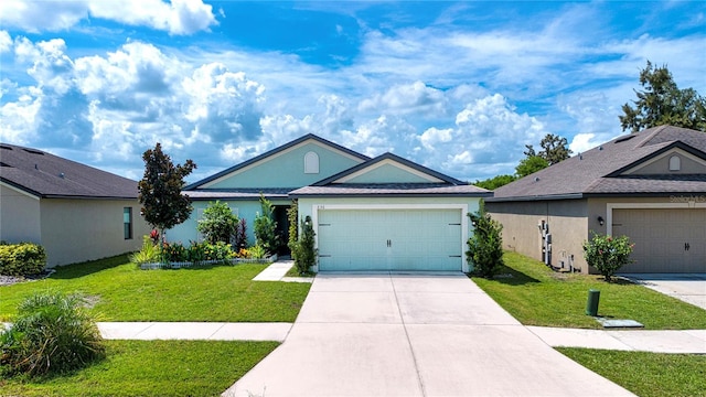 ranch-style house featuring a garage and a front lawn