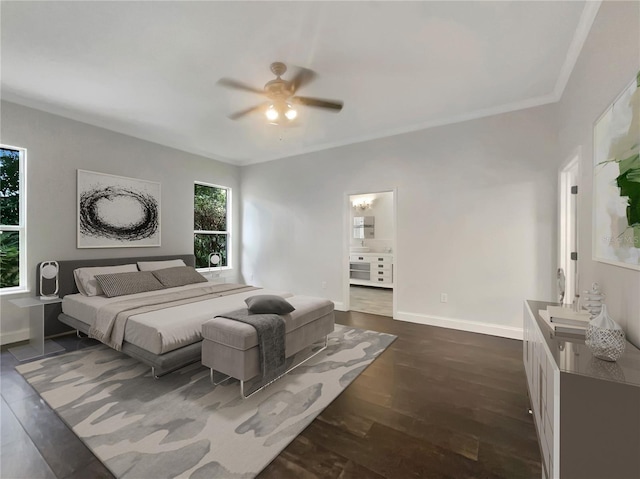 bedroom featuring baseboards, connected bathroom, ceiling fan, dark wood-type flooring, and crown molding