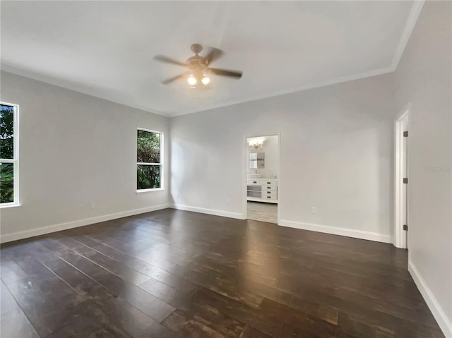 spare room featuring ceiling fan, dark wood-type flooring, and ornamental molding