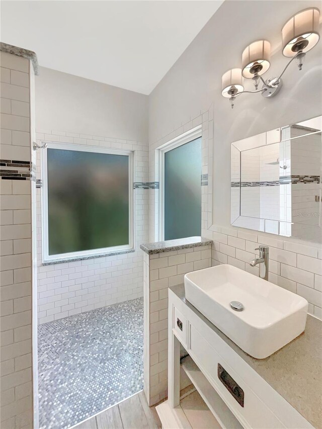 bathroom featuring tile walls and vanity